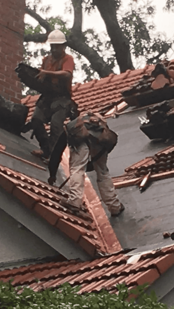 A group of workers are working on a roof.