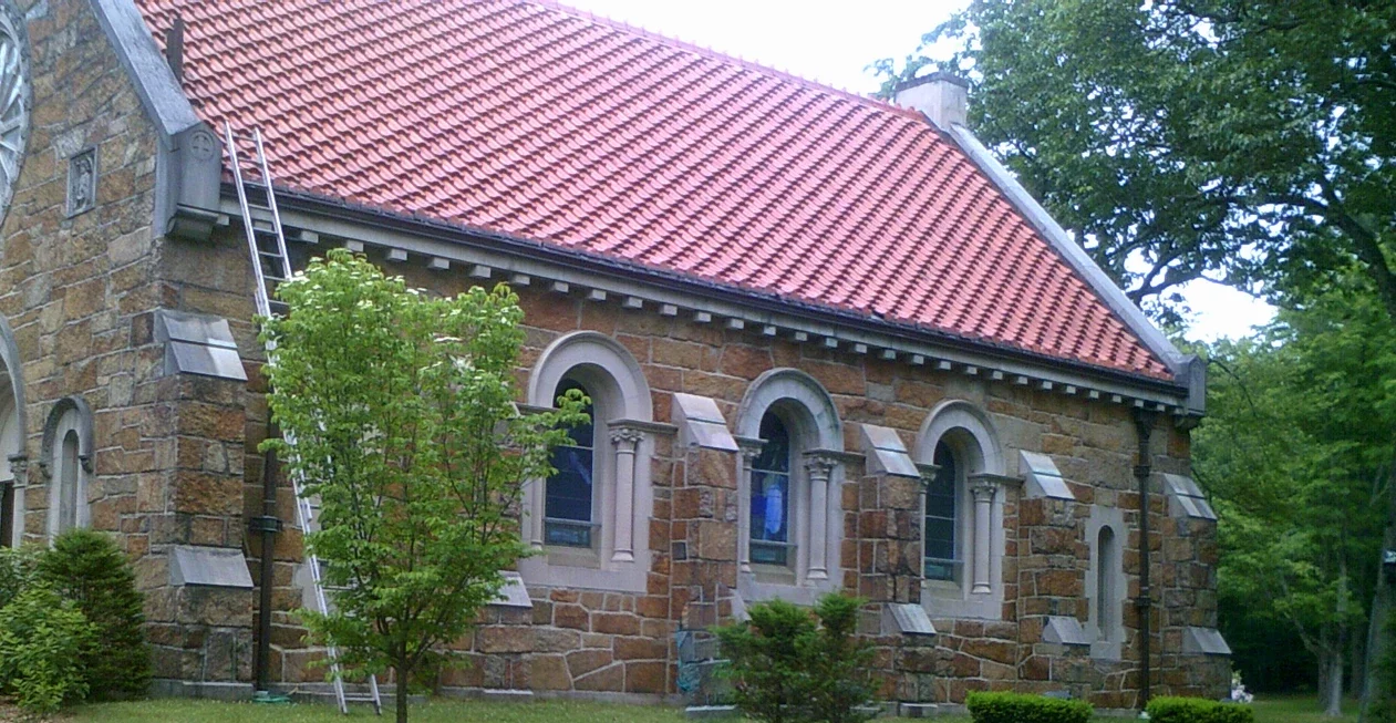 a brick building with a red roof.