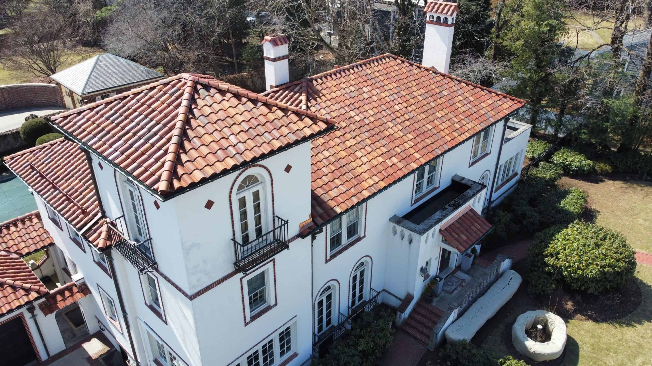 an aerial view of a house with a red tile roof.