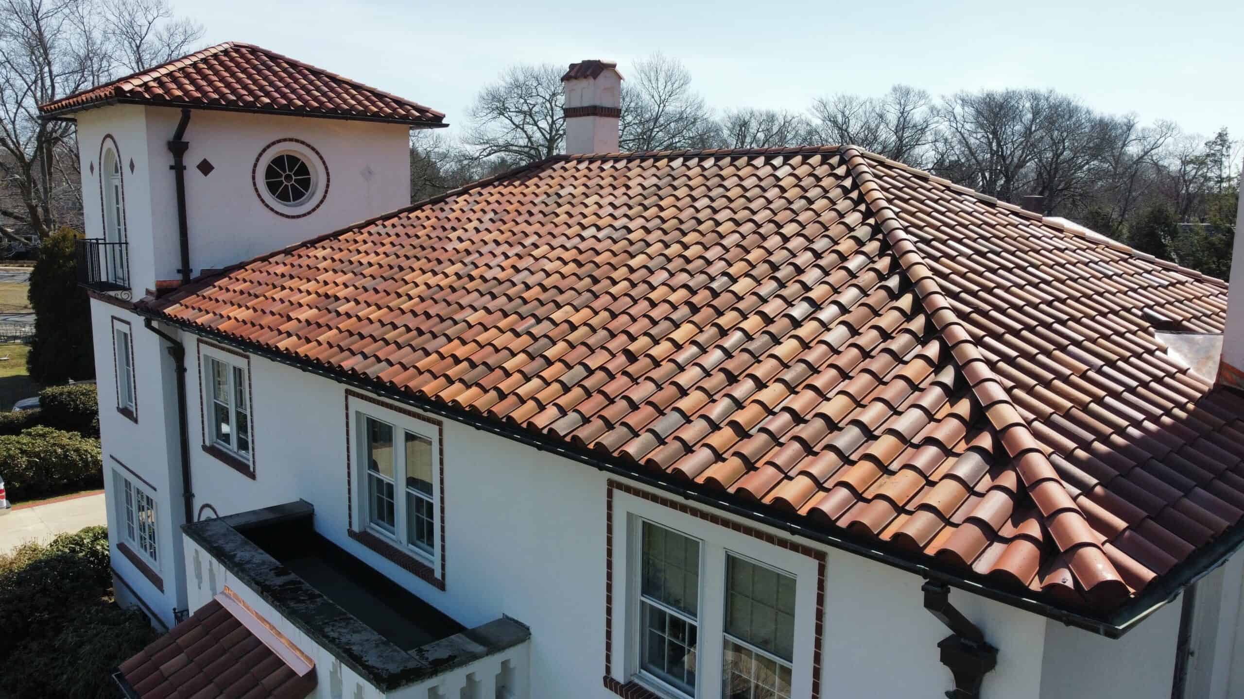 an aerial view of a house with a red tile roof.