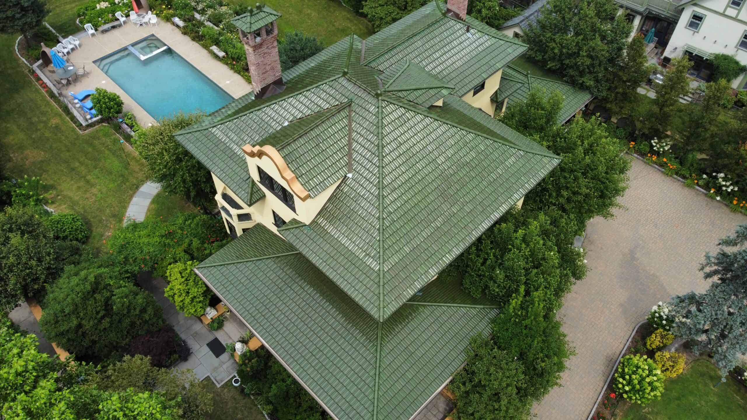 an aerial view of a green roofed house.