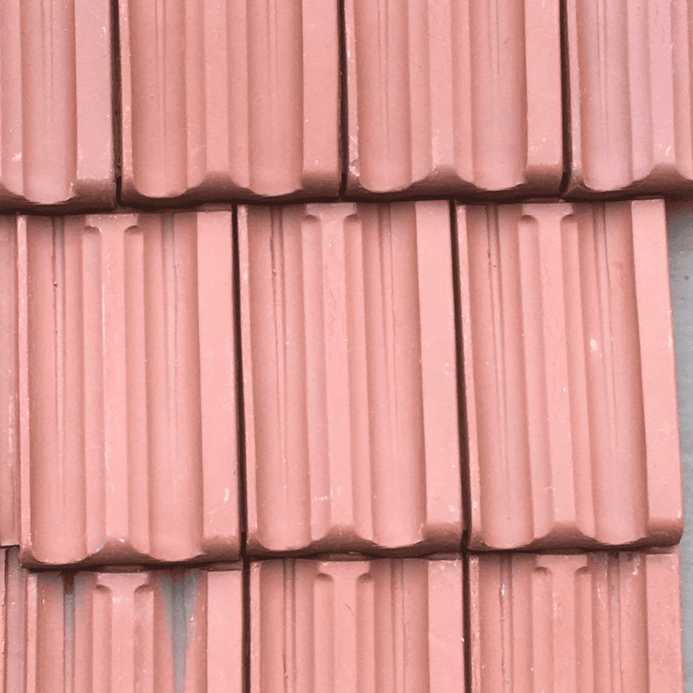 a row of red clay tiles on a wall.